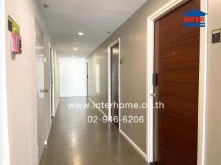 Modern hallway with wooden doors and tiled floor