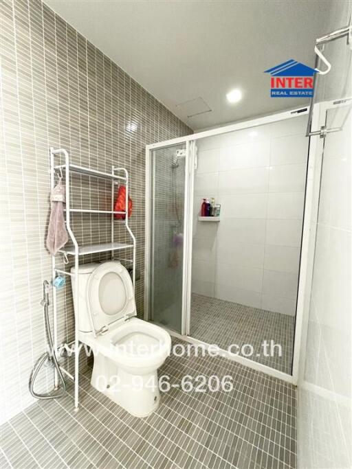 Modern bathroom with shower and toilet.