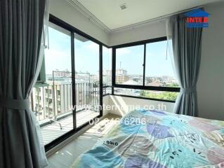 Bright bedroom with large windows and a view