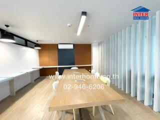 meeting room with long wooden table and chairs