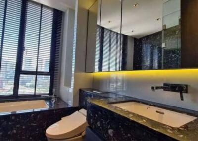 Modern bathroom with large window, bathtub, and vanity