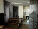 Modern dining area with wooden table adjacent to sleek kitchen