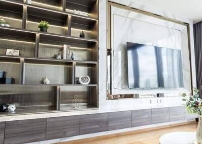 Modern living room with built-in shelving and large TV