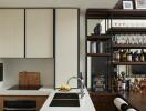 Modern kitchen with a counter, sink, and a well-organized liquor and glassware shelf