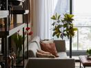 Living room with a view, featuring modern decor and a glimpse of cityscape