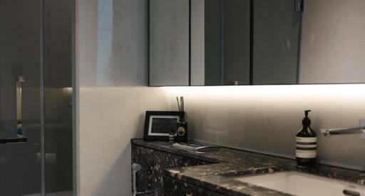 Modern bathroom with marble countertop and mirrored cabinets