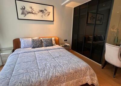 Modern bedroom with wall art and large wardrobe