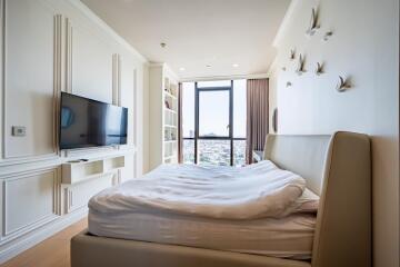 Bedroom with a large window, TV, and modern decor