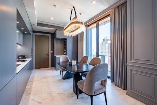 Modern dining room with a black dining table, grey chairs, and a large window offering city views