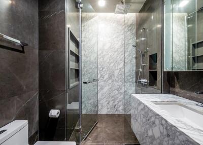 Modern bathroom with glass shower and marble surfaces