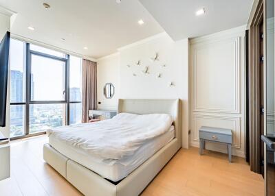Modern bedroom with large window and decorative elements