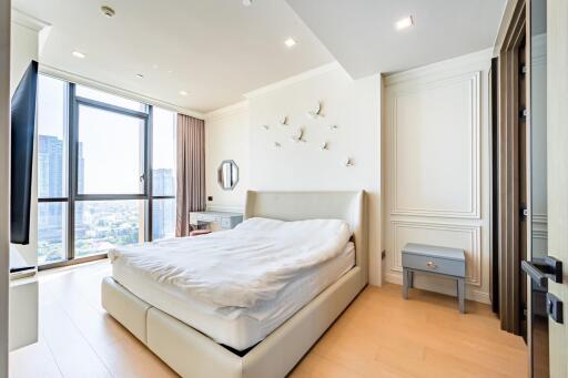 Modern bedroom with large window and decorative elements