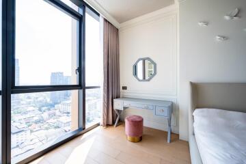 Bright bedroom with large window, modern decor and vanity desk