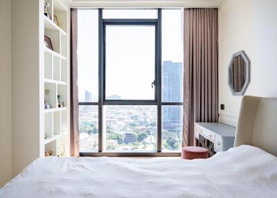 Modern bedroom with a large window and a view