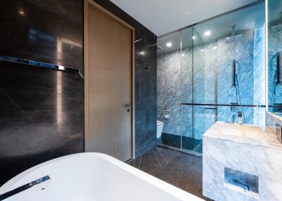 Modern bathroom with marble sink and glass shower enclosure