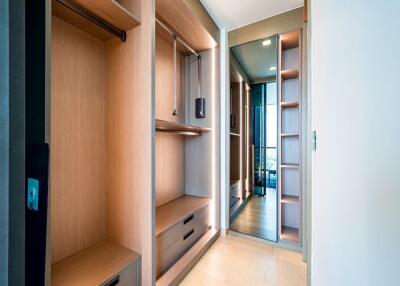 Spacious walk-in closet with built-in storage and mirror