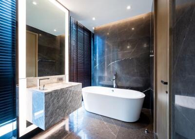 Modern bathroom with freestanding bathtub and marble sink