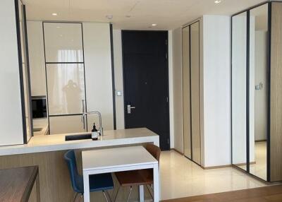 Modern kitchen area with minimalist design and integrated cabinets