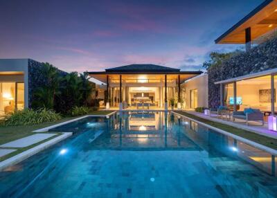 Luxury modern villa with pool at sunset