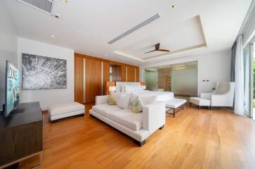 Modern living room with white sofas and hardwood floor