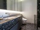 Modern bathroom with marble finishes and a large mirror