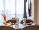 Elegant dining area with table setting and large window