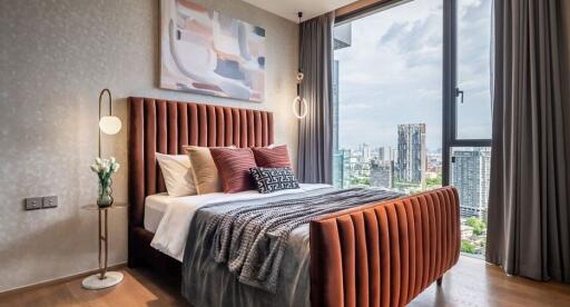 Modern bedroom with a city view, large windows, and stylish decor