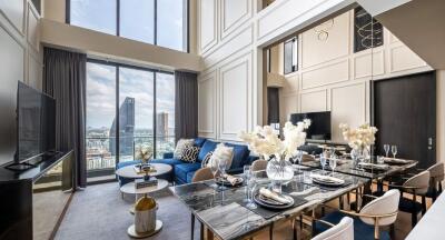 Living room with dining area, large windows, and modern decor