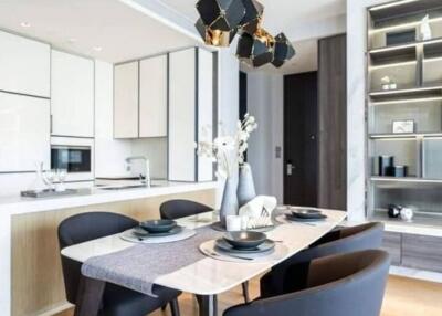 Modern dining room with a dining table and chairs, adjacent to the kitchen