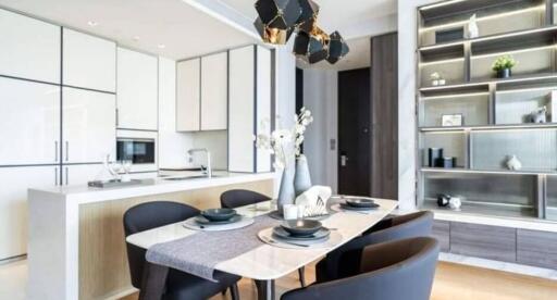 Modern dining room with a dining table and chairs, adjacent to the kitchen