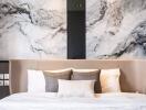 Modern bedroom with marble accent wall and neutral bedding