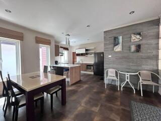 Modern kitchen and dining area with table, chairs, and appliances