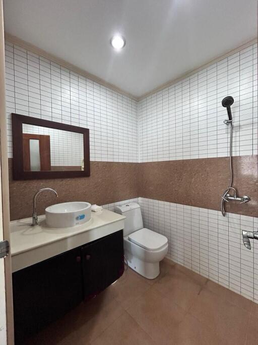 Modern bathroom with white tiles and brown accents