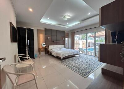 Spacious bedroom with modern furnishings and large windows