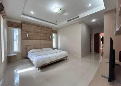 Modern bedroom with double bed, built-in wardrobe, and natural light