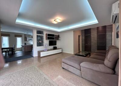 Spacious and modern living room with comfortable seating and built-in storage