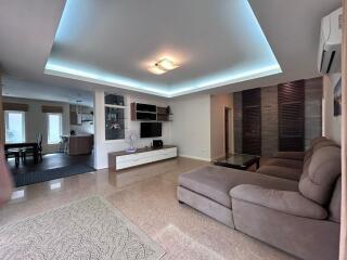 Spacious and modern living room with comfortable seating and built-in storage
