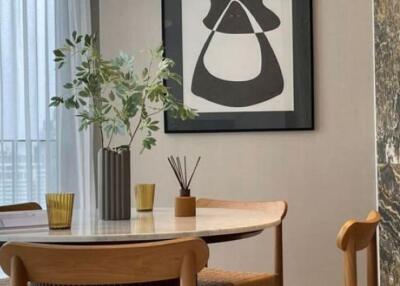 Modern dining room with a round table and abstract wall art