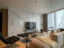 Modern living room with marble wall, flat screen TV, and large windows