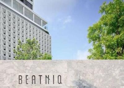 Exterior view of the Beatniq building with surrounding greenery