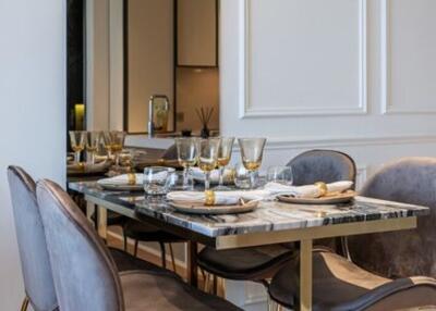 Elegant dining room with a marble table and grey velvet chairs