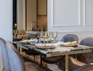 Elegant dining room with a marble table and grey velvet chairs