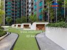 Outdoor communal area with modern seating in front of a high-rise building