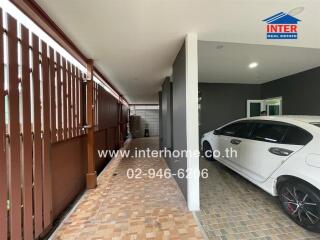 View of an indoor garage with a parked white car