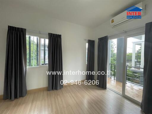 Bedroom with large windows and balcony