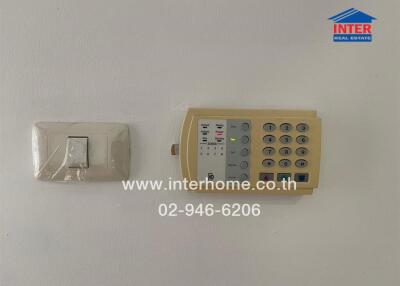alarm system and light switch on a wall
