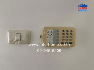 alarm system and light switch on a wall