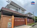 Modern two-story house exterior with fence and gate