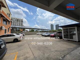 Parking area with multiple cars outside a residential building