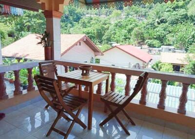 Balcony with a view and wooden furniture